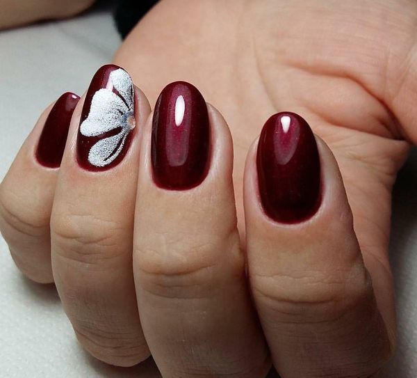 elegant burgundy manicure with flower decoration