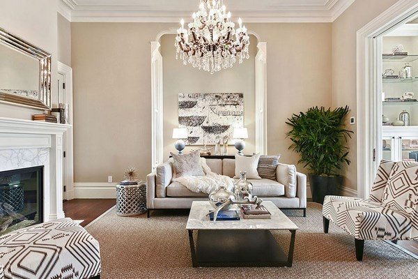 traditional style formal living room with chandelier and fireplace sofa armchairs