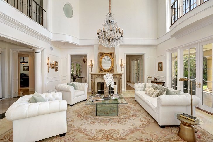 traditional style formal room with glass coffee table sofa fireplace
