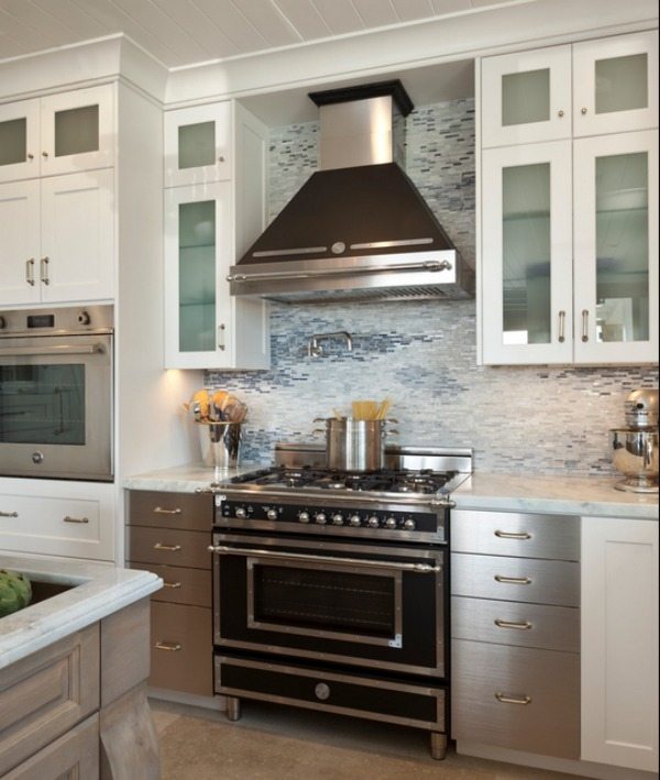 Stainless steel in modern kitchen white wood cabinets natural stone countertop