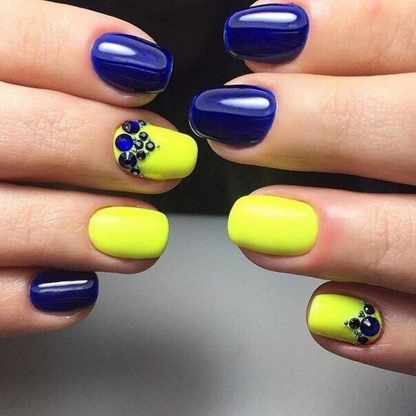 blue and yellow nail design with rhinestones