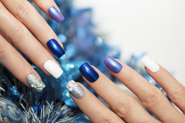 festive blue manicure with white and silver accents
