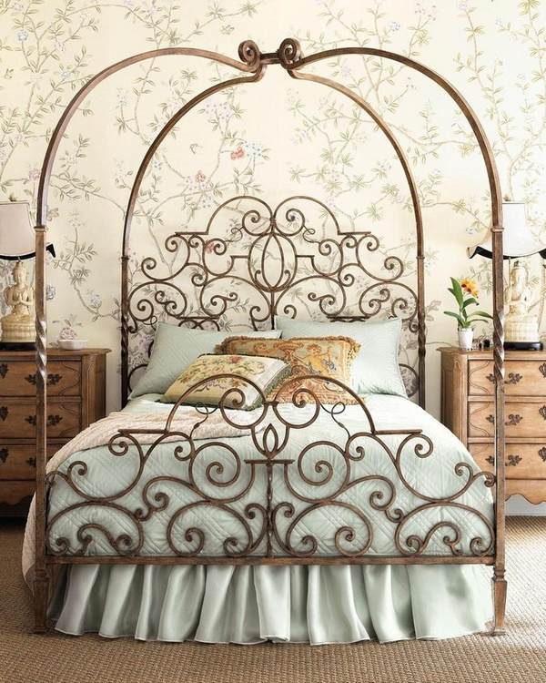 wrought iron canopy bed with ornate headboard and footboard