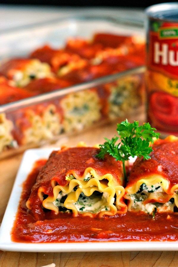 lasagna rolls with spinach and cheese in tomato sauce