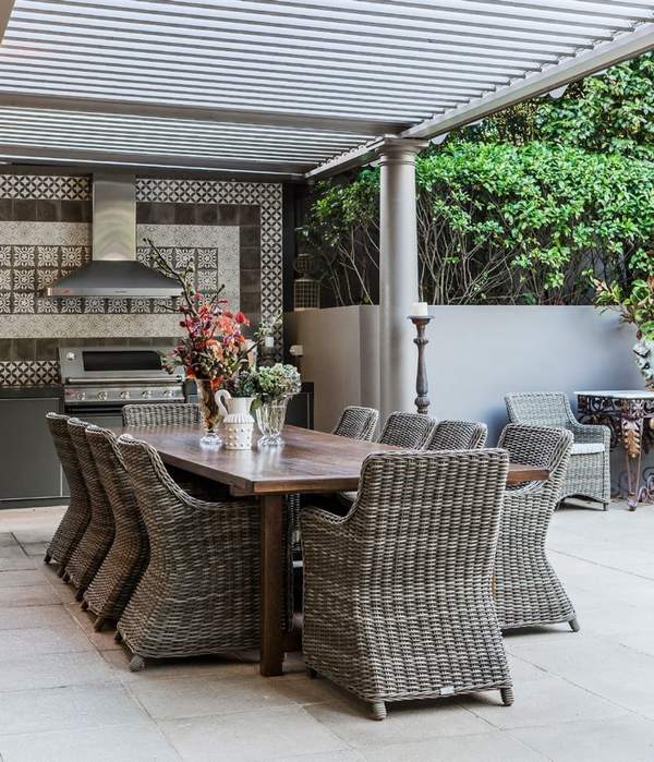 outdoor kitchen design rattan armchairs wooden table floor tiles
