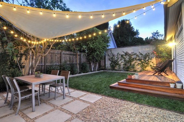 small garden shade string lights outdoor dining furniture