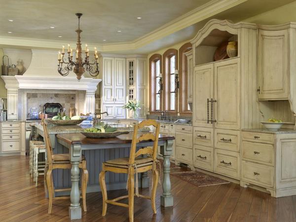 French country style kitchen with vanilla cabinets and blue island