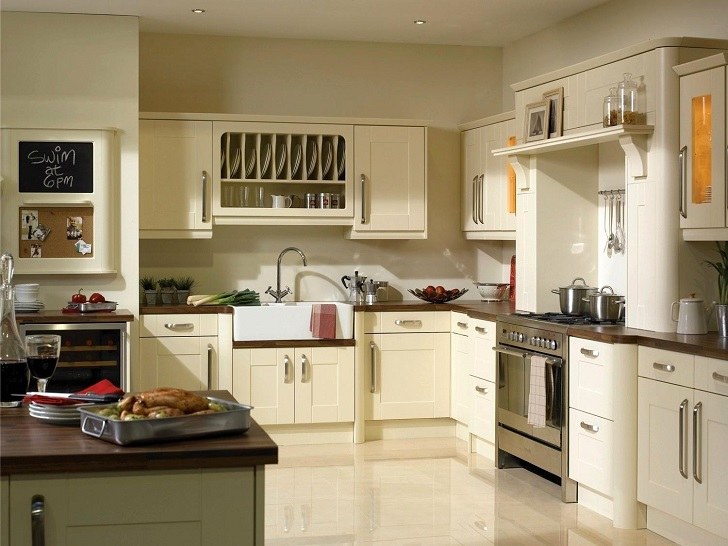 contemporary vanilla cream kitchen cabinets tile flooring stainless steel appliances