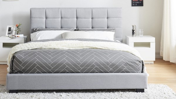modern gray upholstered bed shaggy rug wood flooring