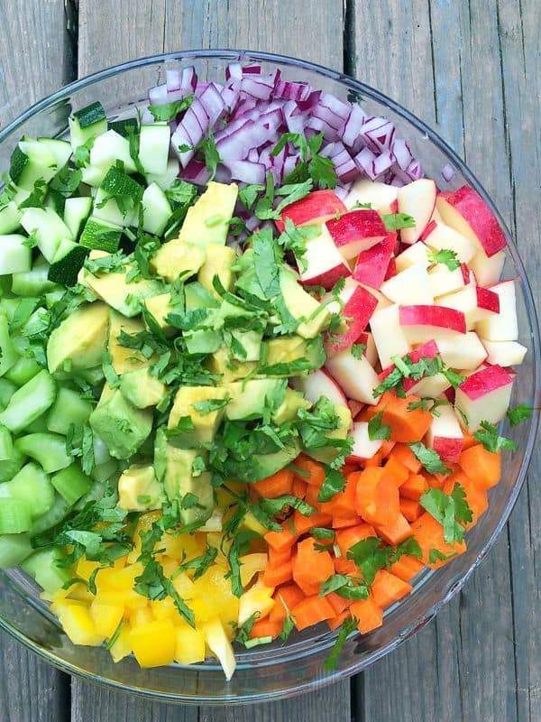colorful rainbow salad with apples and avocado