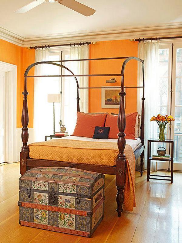 bedroom color scheme orange walls wood flooring canopy bed