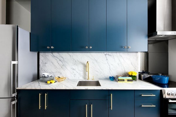 small kitchen design with blue cabinets and white marble backsplash
