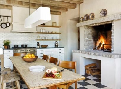Farmhouse-kitchen-with-fireplace-white-cabinets-and-floor-tiles