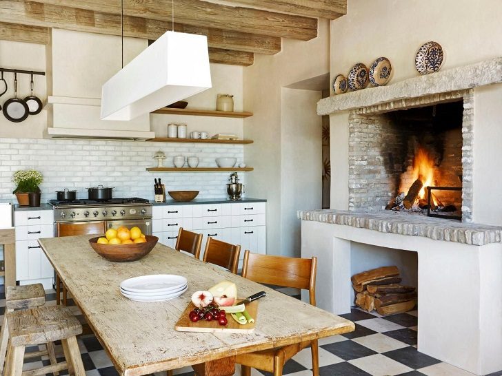 Farmhouse kitchen with fireplace white cabinets and floor tiles