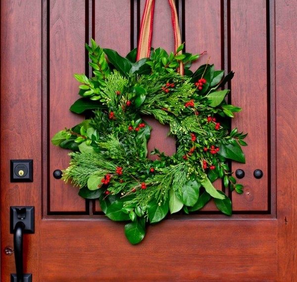 christmas wreath on front door from fresh evergreens