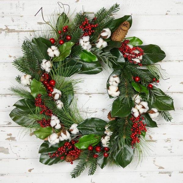 christmas wreath with evergreen magnolia leaves red berry cotton and pine cone