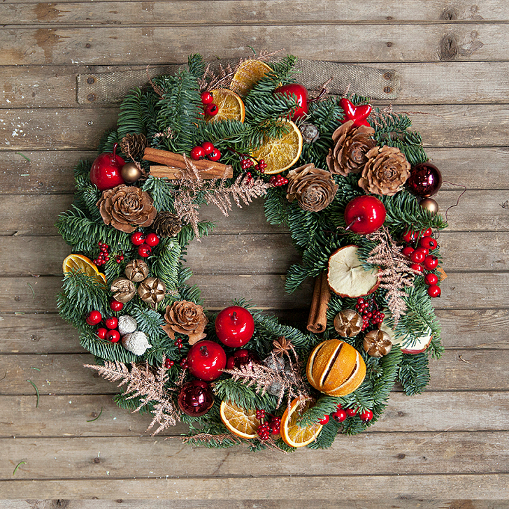 festive christmas wreath for front door with dried fruits