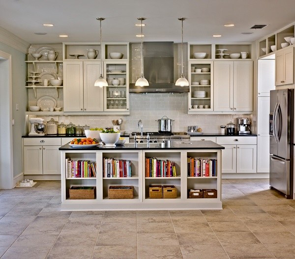white kitchen island with open shelves and black countertop pendant lights