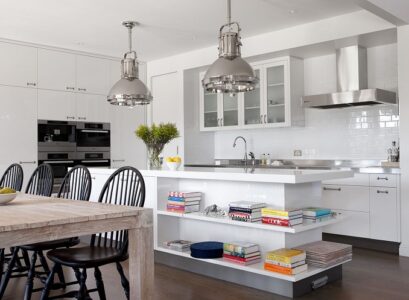 white-kitchen-island-with-open-shelves-wood-dining-table-and-black-chairs