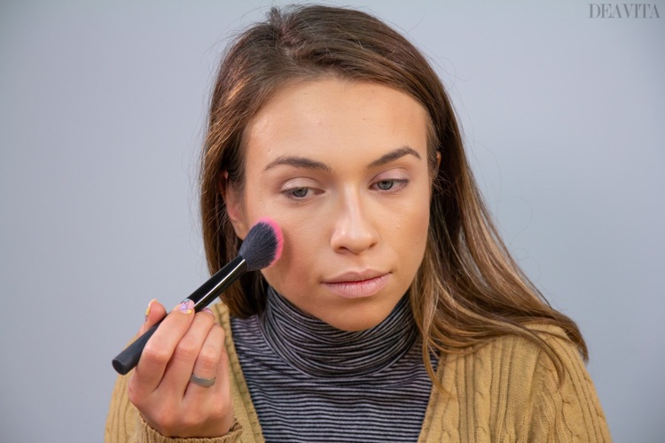 Apply blush on the cheeks with a fluffy angled brush