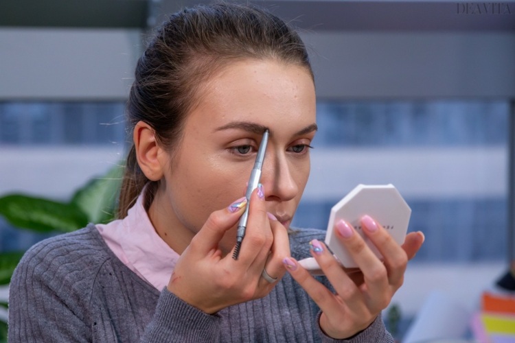 Comb the eyebrows and fill any sparse areas with a pencil