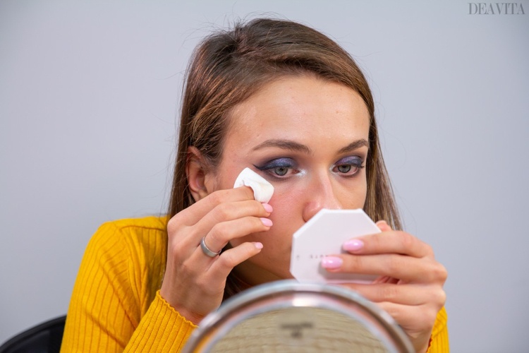 Soak a cotton pad with micellar water to clean the face