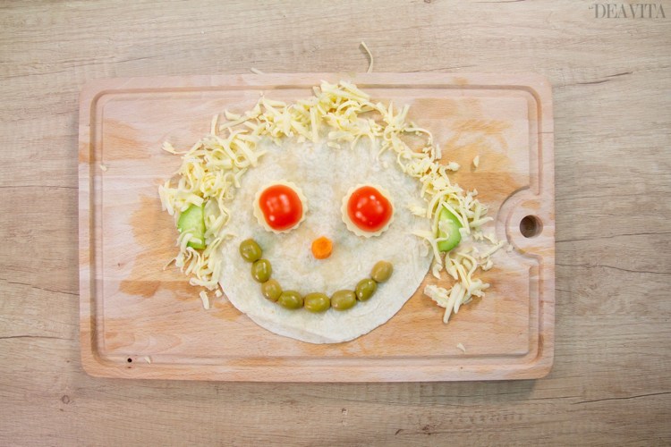 Tortilla Faces with vegetables olives and cheese