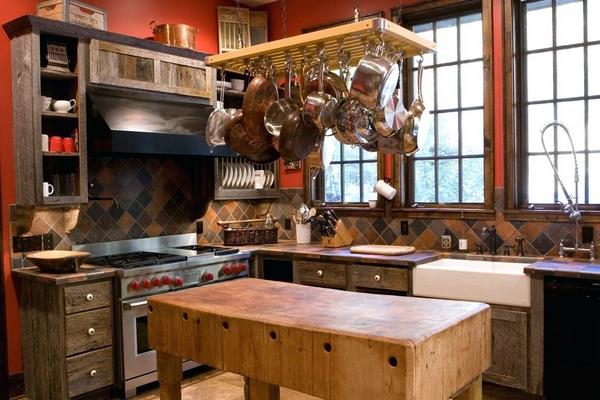 rustic kitchen with pot rack above small island