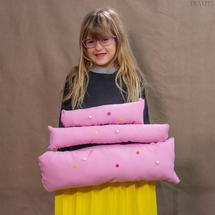 DIY cupcake costume with pillow stuffing and pompons in pink and yellow