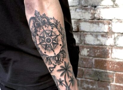 Compass-and-palm-trees-tattoo-on-forearm