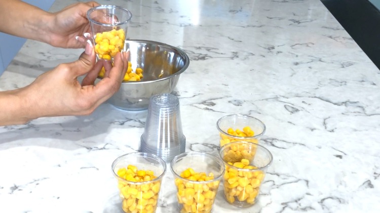 fill plastic cups with canned corn