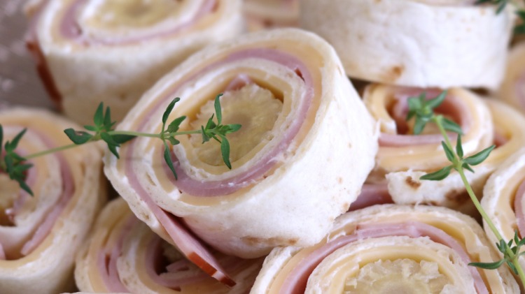 finger food snacks tortilla rolls with ham and cheese 