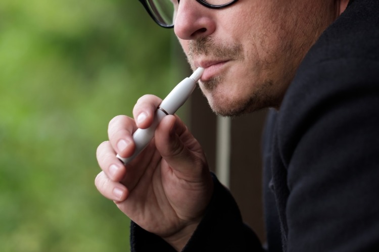 a man smoking hybrid cigarette