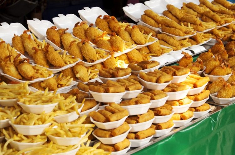 a variety of fried food with bread crumb on the stand