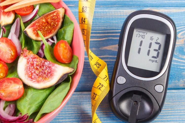 cancer prevention with nutrition salad with figs and spinach on table with measure tape