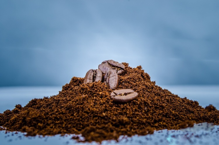 closeup ground coffee and beans