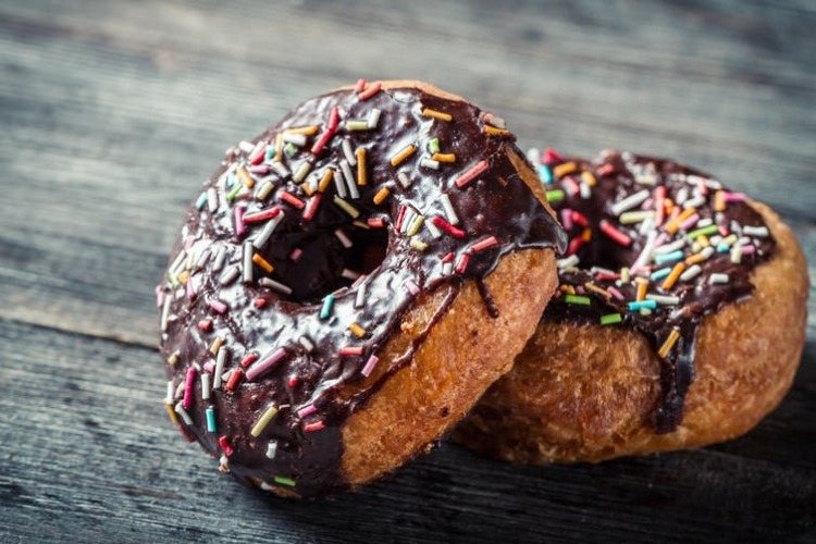 donuts with chocolate glaze and colorful sprinkles are harmful food