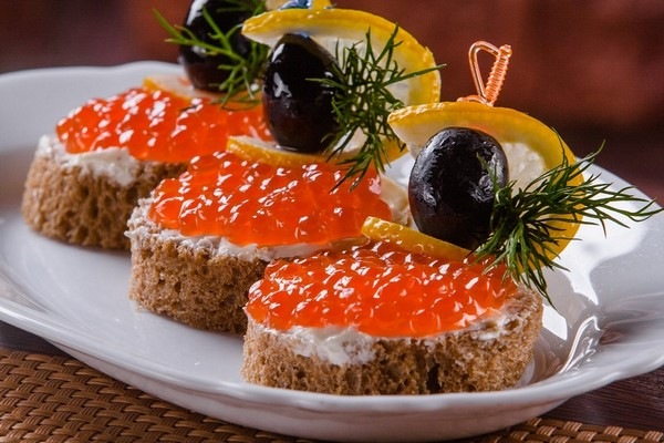 festive appetizers with caviar olives and lemon slices