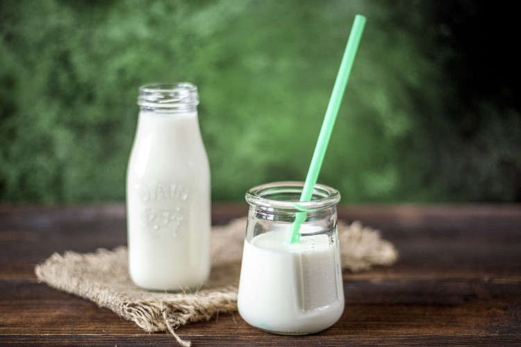 cancer prevention with nutrition glass bottle with milk and glass with straw 