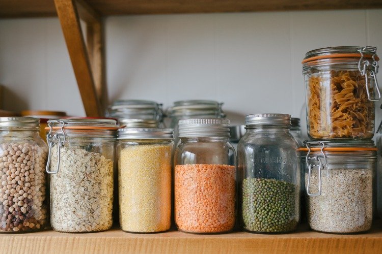 glass jars filled with oats lentils soy and pea for vegan diet