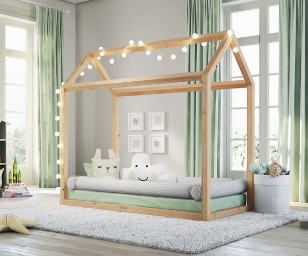 low bed for kids decorated with led string lights on thick carpet