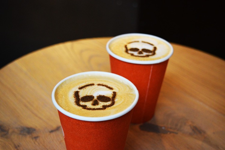 is caffeine harmful to health two cardboard cups with skull shape