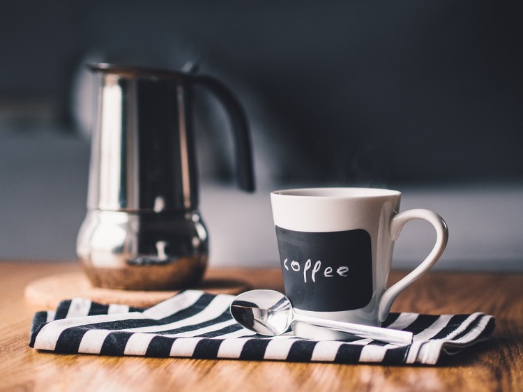 morning cup of coffee on pleated tablecloth and wooden table