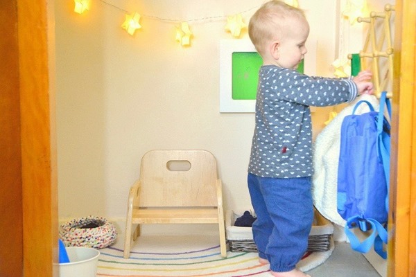 small child hanging his clothes montessori bedroom design ideas