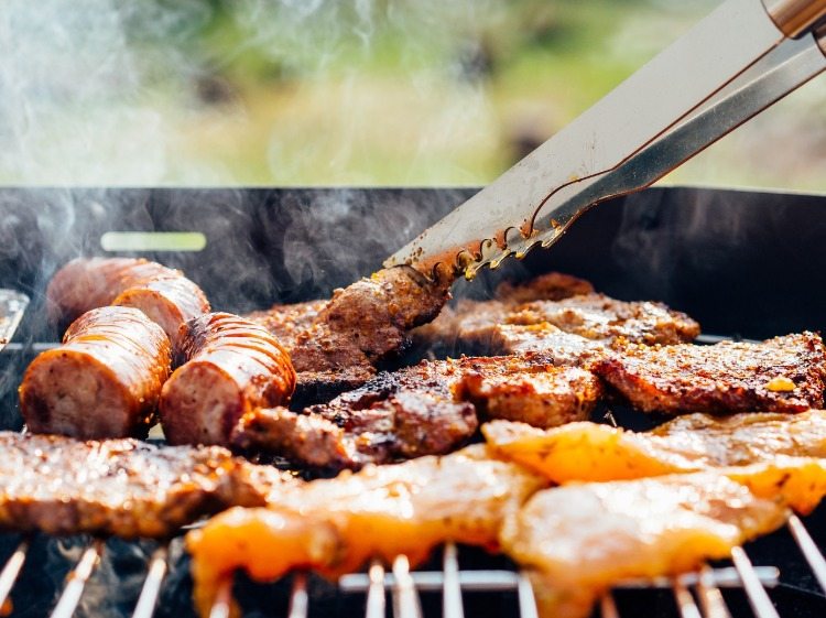 steaks sausage and chicken breast on the grill