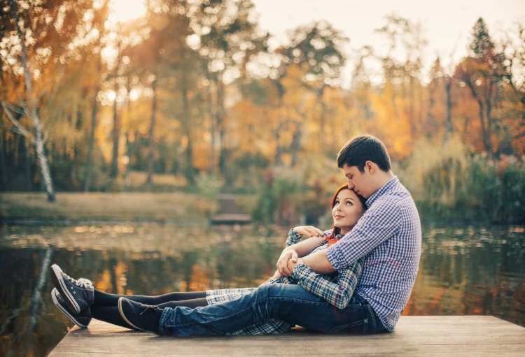 young couple hugging on a platform in the nature