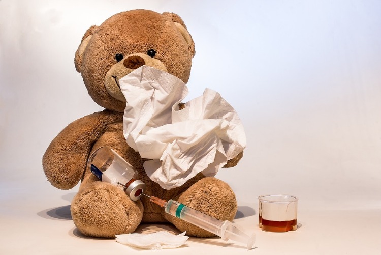 teddy bear with drug and handkerchief as symbol for sick child