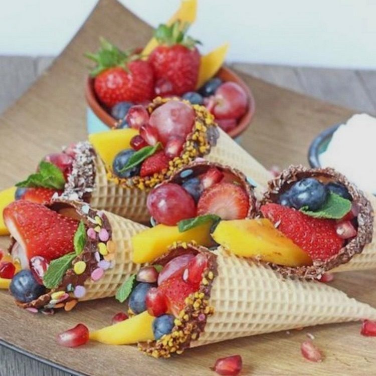 ice cream cones filled with fruit strawberry raspberry peaches 