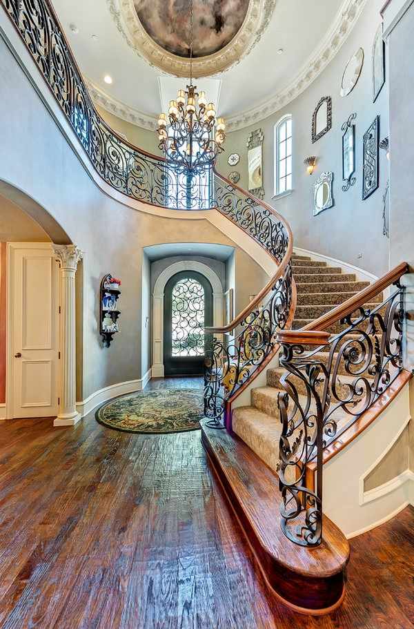 entry hall decoration wood flooring and round carpet wrought iron railings