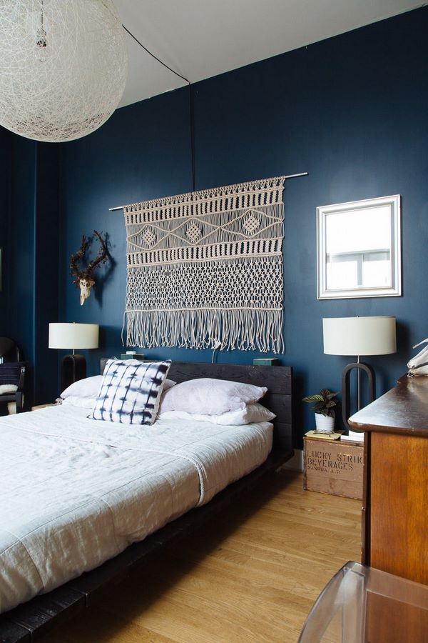bedroom wall decoration with beautiful macrame against dark blue wall